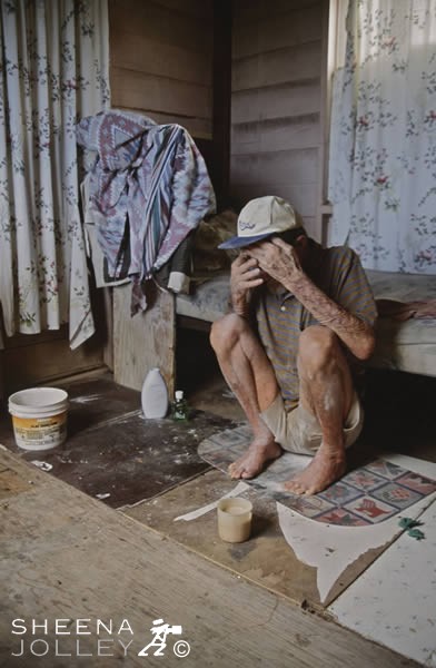 Chris Watson hides his Face.jpg - Chris was a fisherman all his life. The blistering sun has resulted in him having horrendous skin cancer on his face